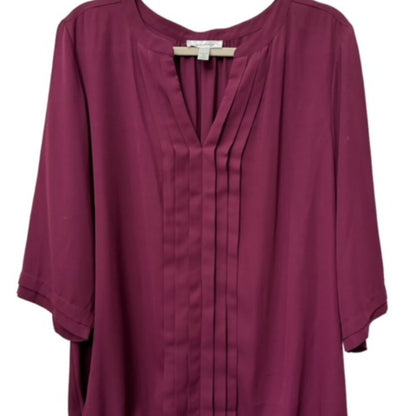 A women's long-sleeve blouse in a deep plum or burgundy shade, featuring a split V-neckline with pleated detailing down the center front, shown against a plain white background.