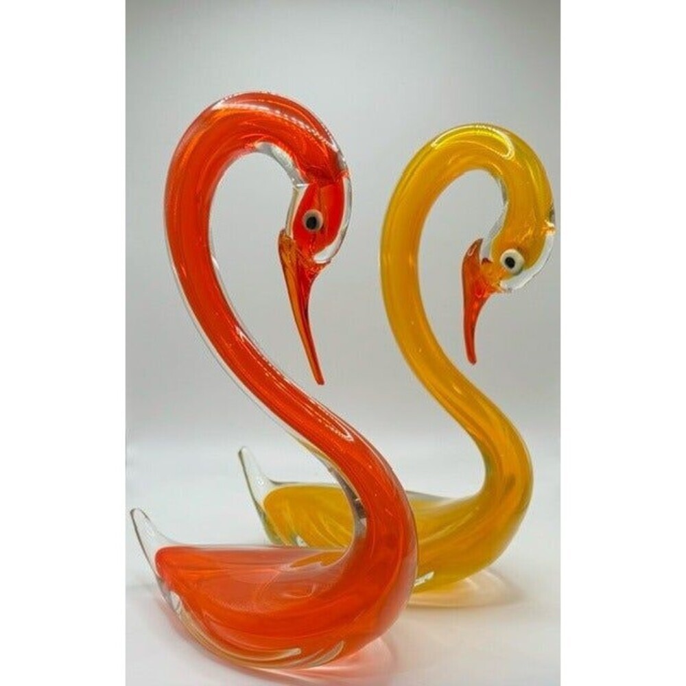 Pair of vintage art glass swan figurines in bright red orange and golden yellow with curved necks and clear glass accents
