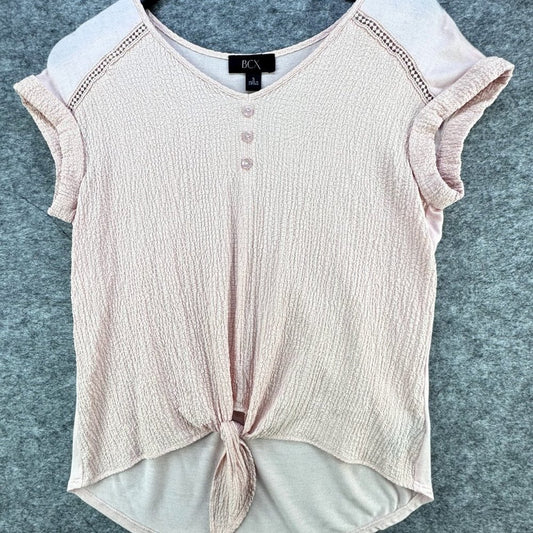 A light pink textured knit top with a V-neck, three-button placket, ruffled cap sleeves, and a front knot detail, laid flat on a gray felt background.