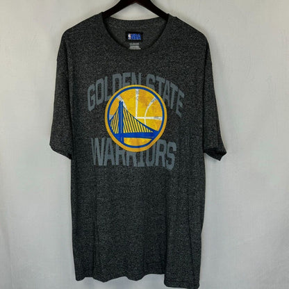 A dark heather gray Golden State Warriors t-shirt hanging on a black hanger against a light gray wall. The shirt features a distressed yellow and blue circular Warriors logo in the center with 'GOLDEN STATE WARRIORS' text arched above and below in gray.
