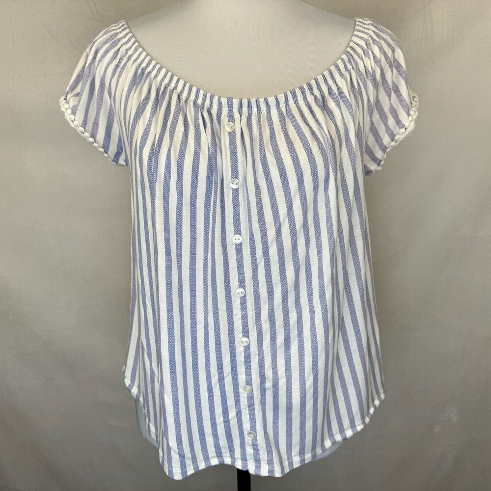 A blue and white vertically striped off-the-shoulder blouse with a button-down front, displayed on a mannequin torso against a neutral gray backdrop.