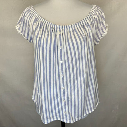 A blue and white vertically striped off-the-shoulder blouse with a button-down front, displayed on a mannequin torso against a neutral gray backdrop.