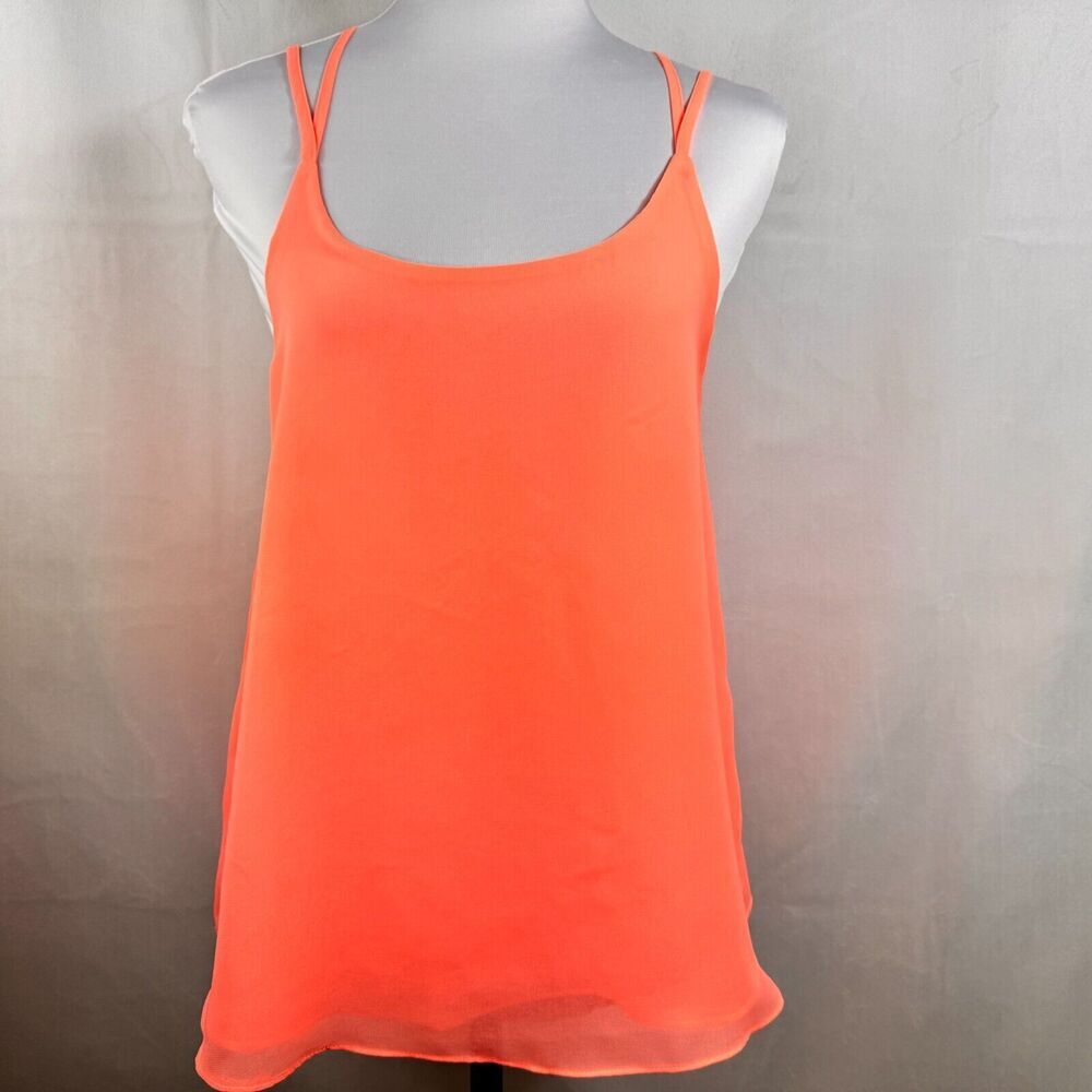 A bright neon orange sleeveless camisole tank top displayed on a white mannequin torso against a neutral gray fabric backdrop.