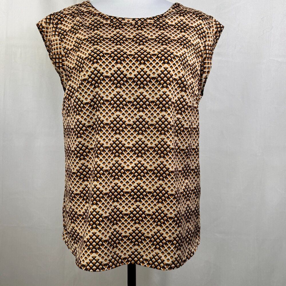 A sleeveless top with a brown and beige geometric pattern, displayed on a mannequin against a light gray background.
