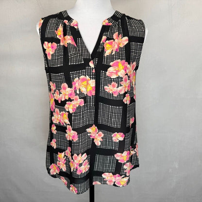 A sleeveless black blouse with a pink and yellow floral print over a white grid pattern, displayed on a white mannequin torso against a light gray background.