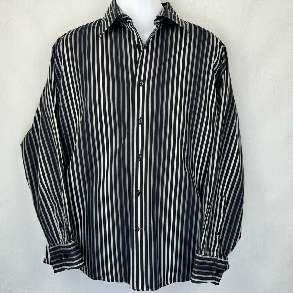 A long-sleeve button-up shirt with vertical black and white stripes, displayed on a white mannequin torso against a light gray textured background.
