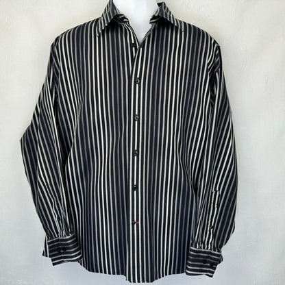 A long-sleeve button-up shirt with vertical black and white stripes, displayed on a white mannequin torso against a light gray textured background.