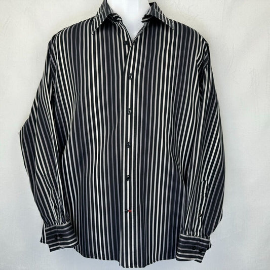 A long-sleeve button-up shirt with vertical black and white stripes, displayed on a white mannequin torso against a light gray textured background.