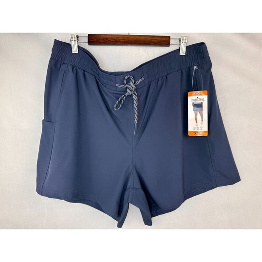 A pair of women's navy blue athletic shorts with a gray and white striped drawstring, hanging on a wooden hanger with white clips against a light beige fabric backdrop. A retail hangtag is attached to the side.