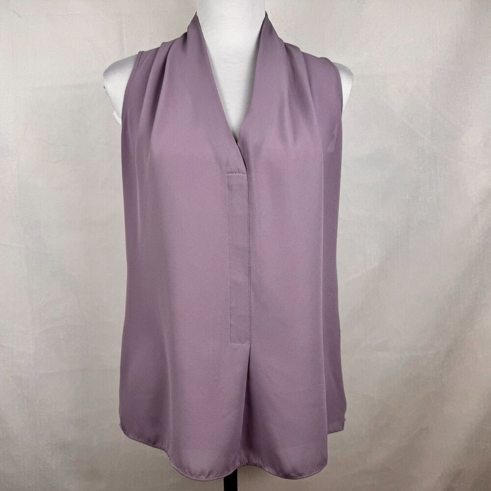 A sleeveless lavender-purple draped vest or shrug displayed on a white mannequin torso against a light gray fabric backdrop.