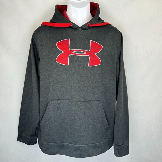 A dark gray Under Armour pullover hoodie with a red Under Armour logo on the chest, a red-lined hood, and a front kangaroo pocket, displayed on a white mannequin torso against a light gray background.