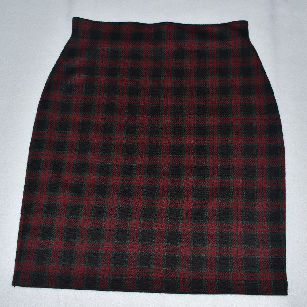 A black and red plaid skirt laid flat on a light gray background.