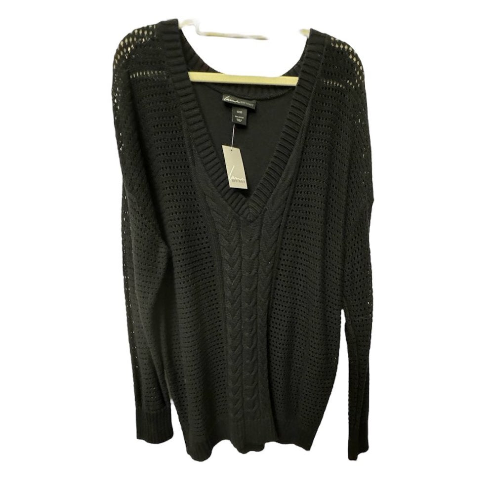 A black knit sweater with a V-neck and textured cable and open-knit patterns, hanging on a wooden hanger against a white background.