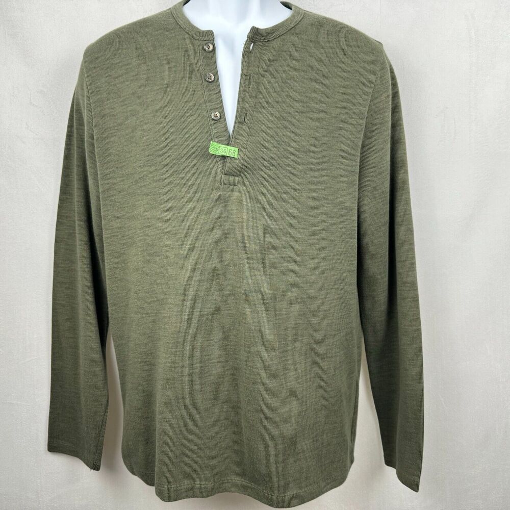 An olive green long-sleeve henley shirt displayed on a white mannequin torso against a light gray fabric background.