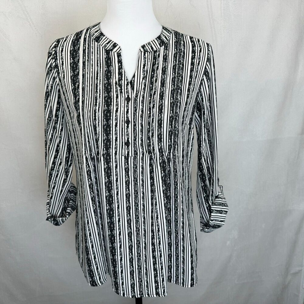 A black and white vertically striped button-up blouse with three-quarter sleeves, displayed on a white mannequin torso against a light gray fabric backdrop.