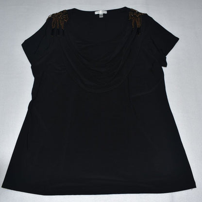 A black short-sleeve top with a draped neckline and brown beaded bow details on the shoulders, laid flat on a light gray background.