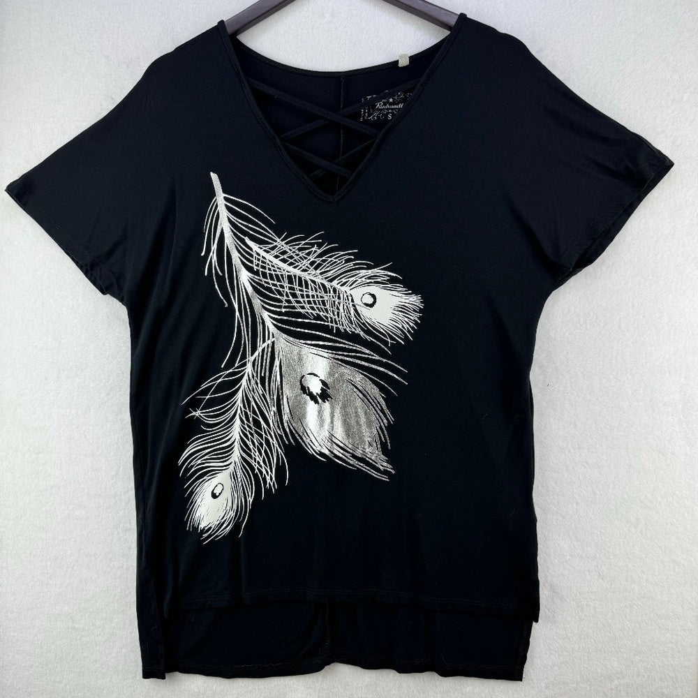 A black short-sleeve V-neck top with a lace-up detail at the neckline and a large white feather graphic on the front, hanging on a dark hanger against a light textured wall.