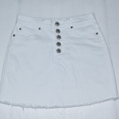 White denim mini skirt with a high waist, five prominent silver-tone front buttons, and a raw frayed hem.