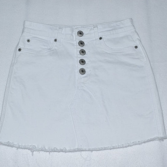 White denim mini skirt with a high waist, five prominent silver-tone front buttons, and a raw frayed hem.