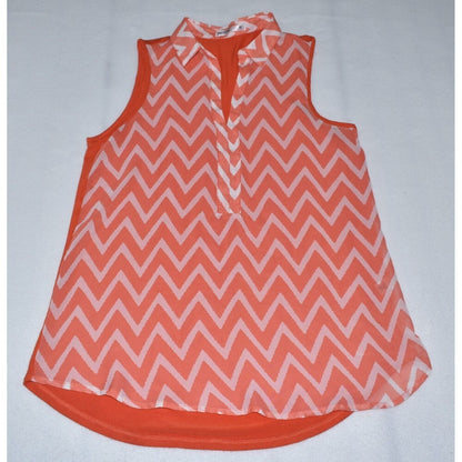 A sleeveless orange and white chevron-patterned blouse with a mock collar and split neckline, laid flat on a light gray background.