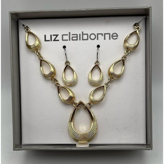 Gold teardrop link necklace and matching drop earrings displayed in a gray jewelry box on a white insert printed with the brand name 'Liz claiborne'.