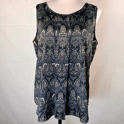 A sleeveless scoop-neck top with a dark navy blue and white paisley pattern, displayed on a white mannequin torso against a light gray fabric backdrop.