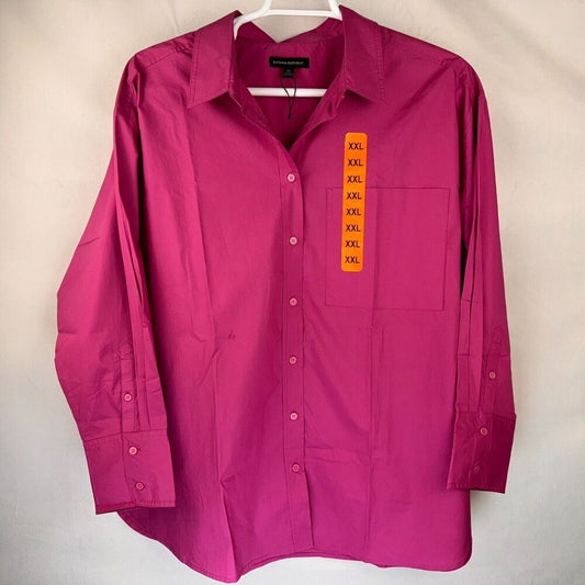 A magenta long-sleeve button-up shirt hanging on a white hanger against a light beige background. The shirt features a vertical orange size tag on the chest pocket listing 'XXXL'.