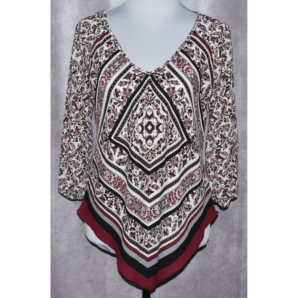 A women's long-sleeve V-neck top displayed on a mannequin torso, featuring a complex geometric and floral mandala pattern in black, white, and burgundy red.