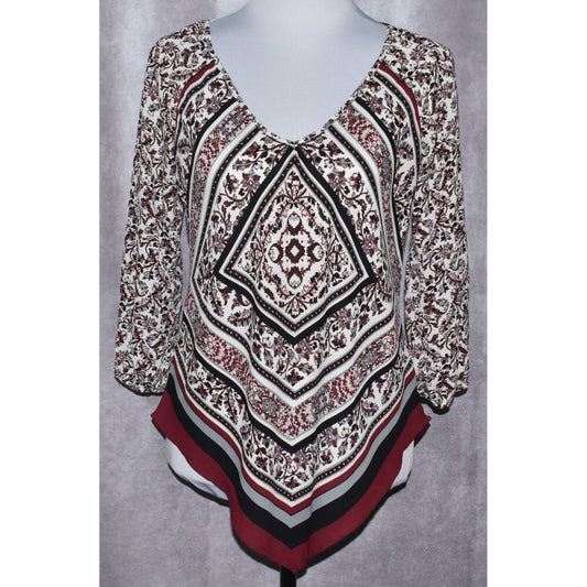 A women's long-sleeve V-neck top displayed on a mannequin torso, featuring a complex geometric and floral mandala pattern in black, white, and burgundy red.