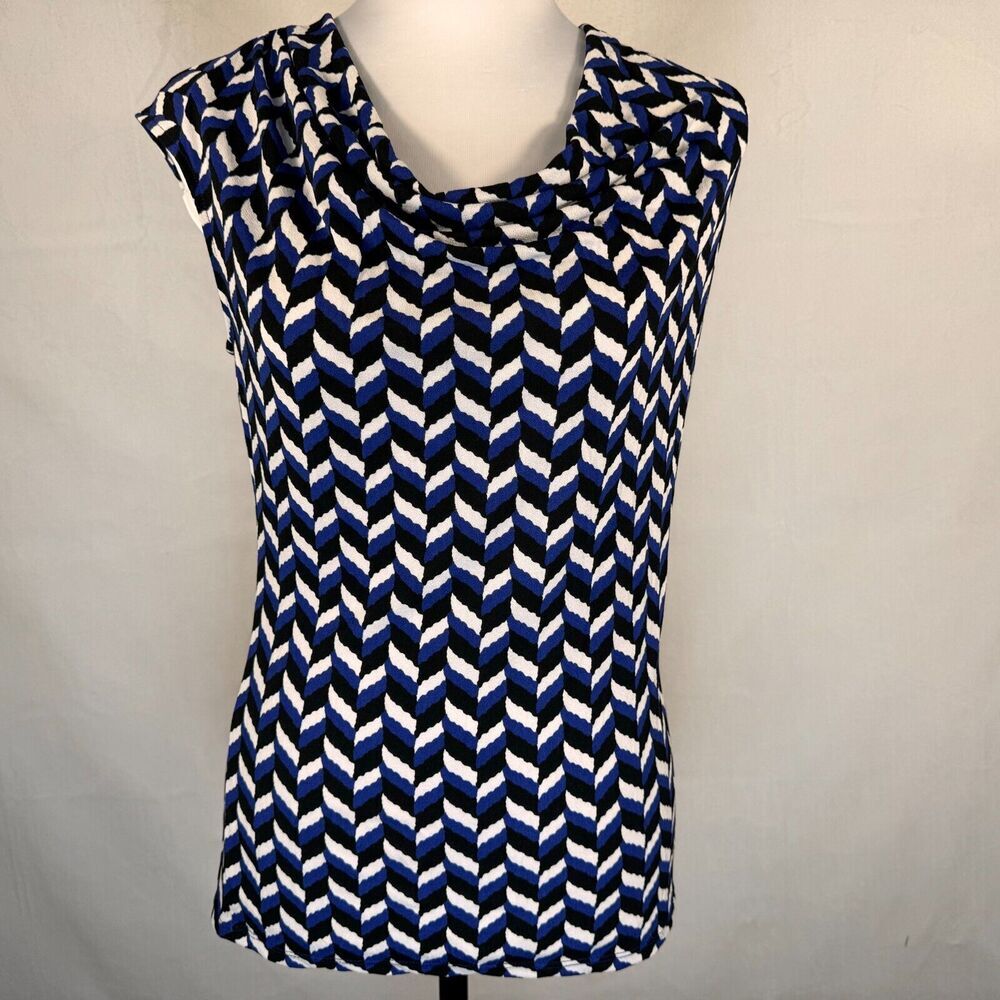 A sleeveless cowl-neck top with a navy blue, white, and black geometric chevron pattern, displayed on a mannequin torso against a light gray background.
