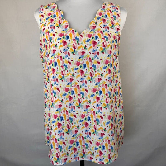 A sleeveless white top with a colorful abstract watercolor print, displayed on a mannequin torso against a neutral gray background.