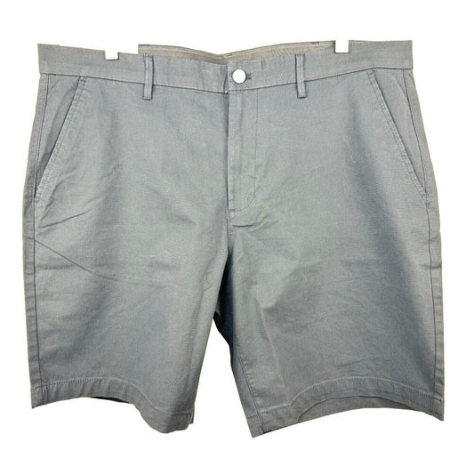 A pair of light gray chino shorts with belt loops, a button closure, and side pockets, shown flat against a white background.