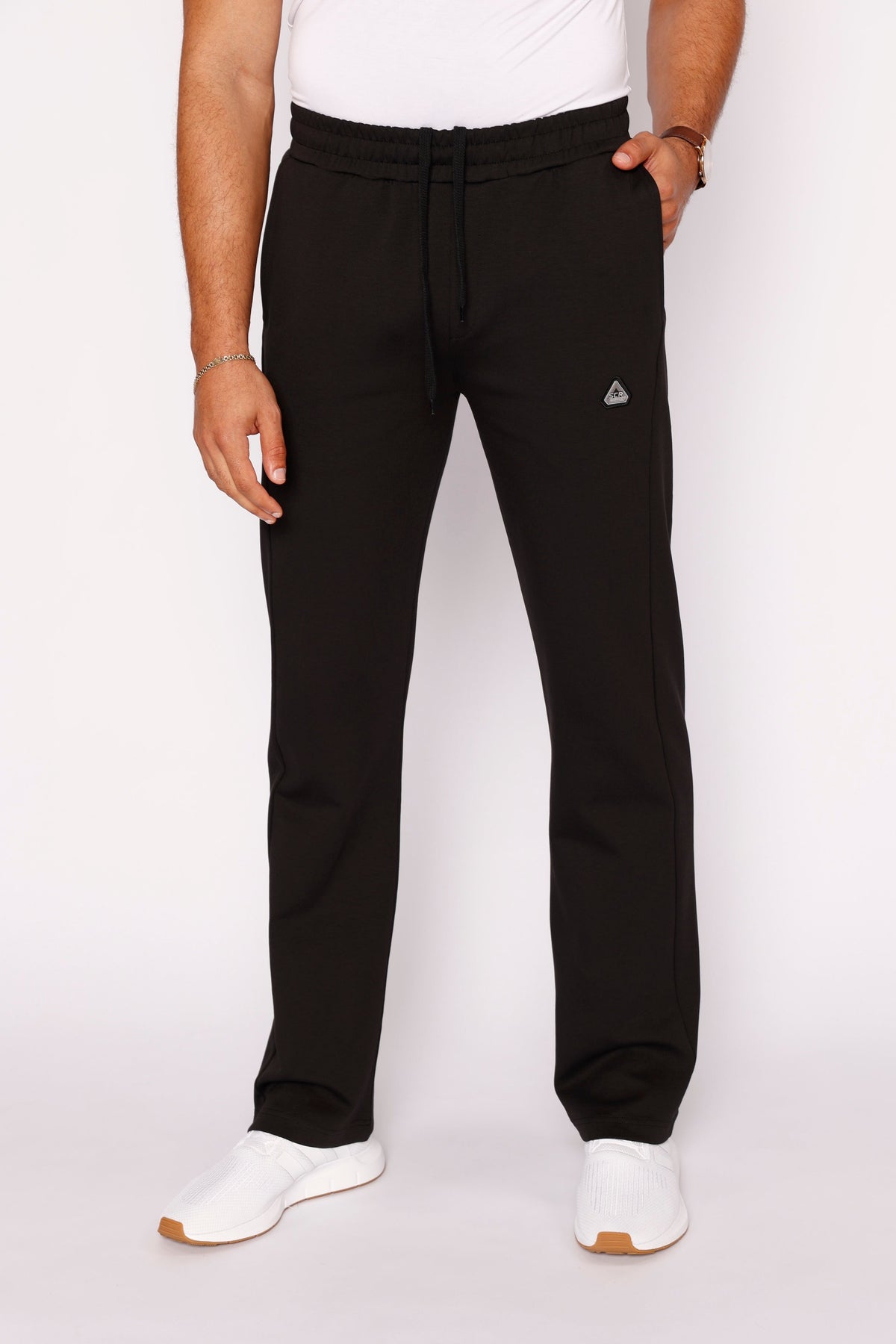 Model wearing black SCR Sportswear men's Classic Athleisure straight-leg tall-fit sweatpants with adjustable drawstring waist and side pockets.
